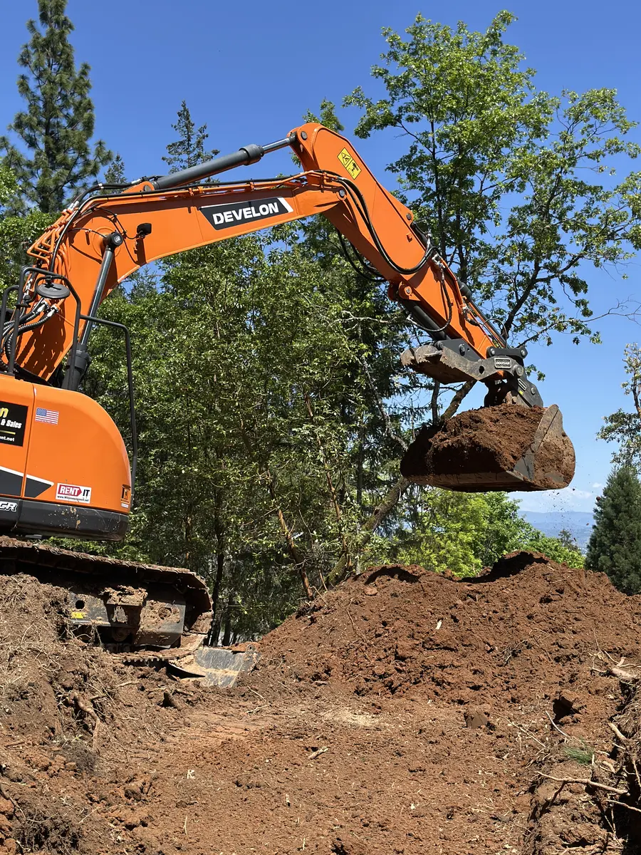 Completed unpaved access road through a wooded Southern Oregon property