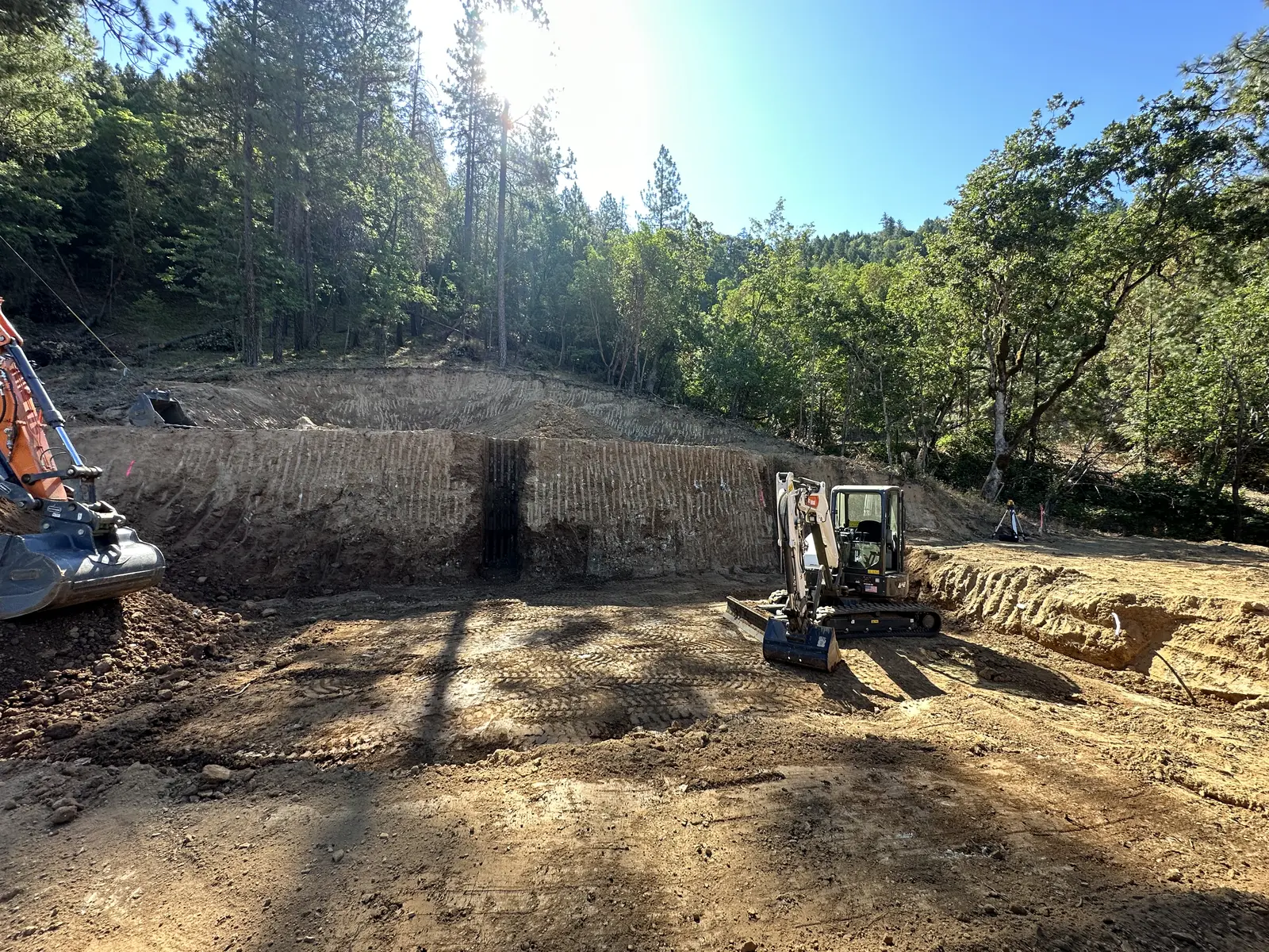 Excavator preparing a wooded Southern Oregon building site